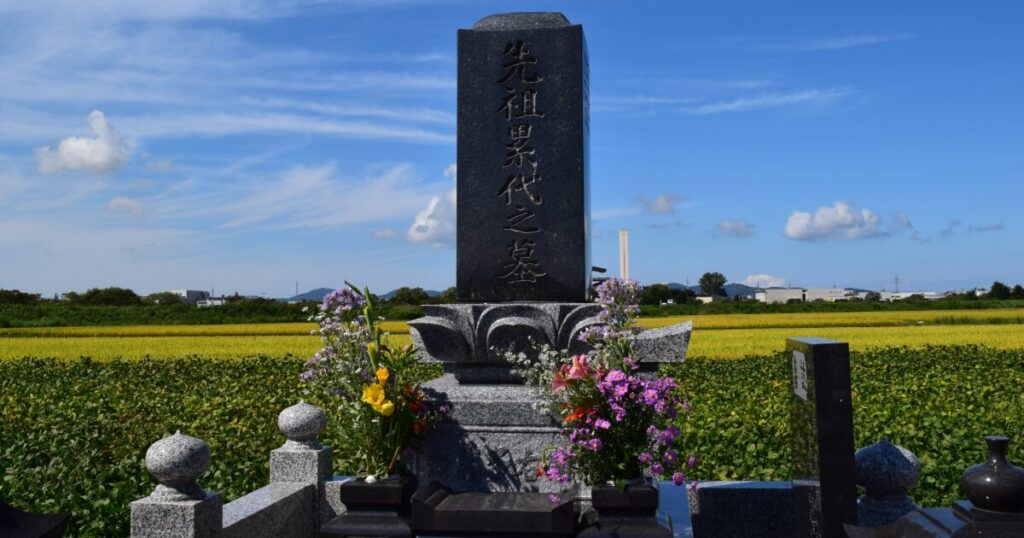 田園風景の中に建つ日本の墓石